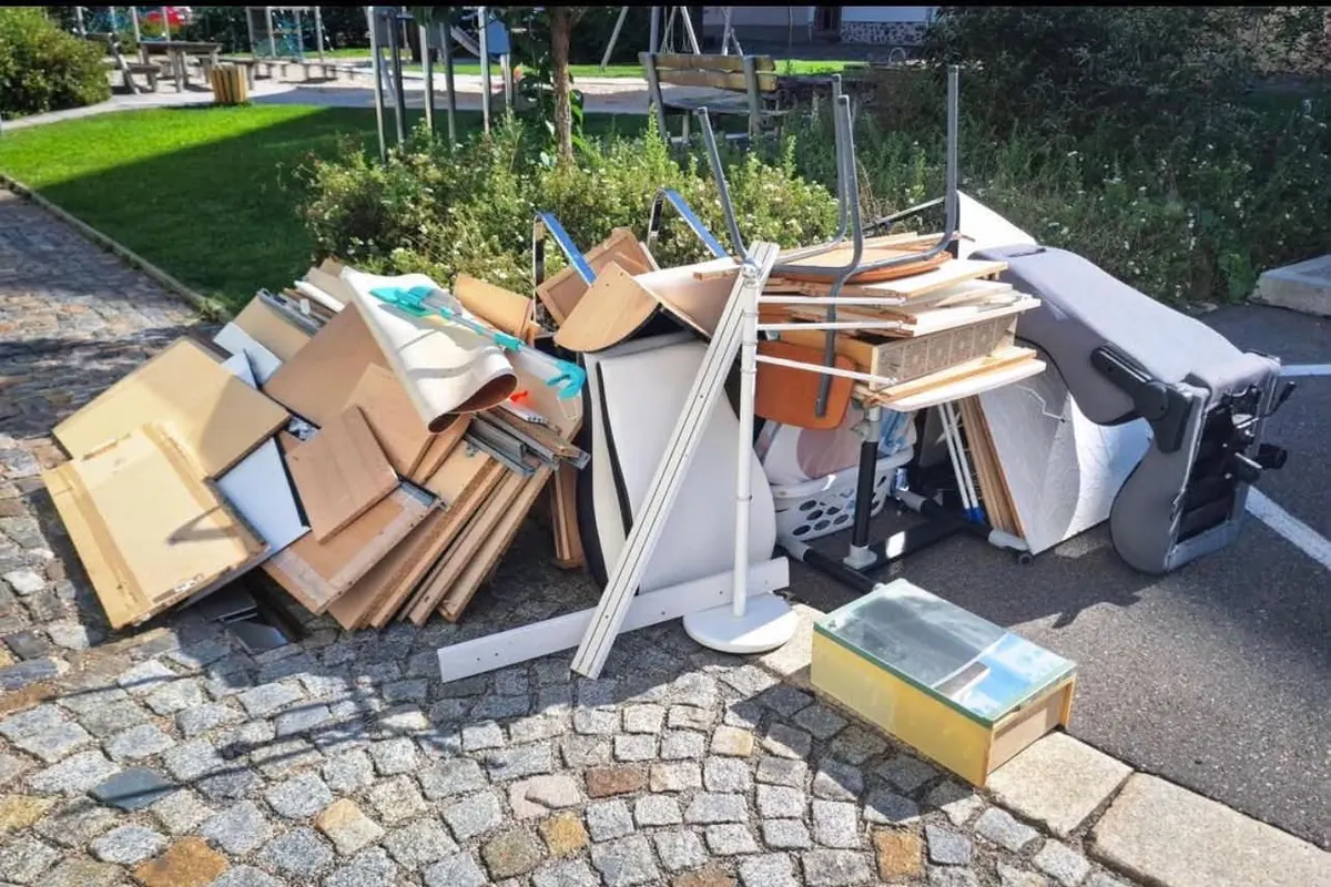 Broken-down furniture and boards stacked at the curb