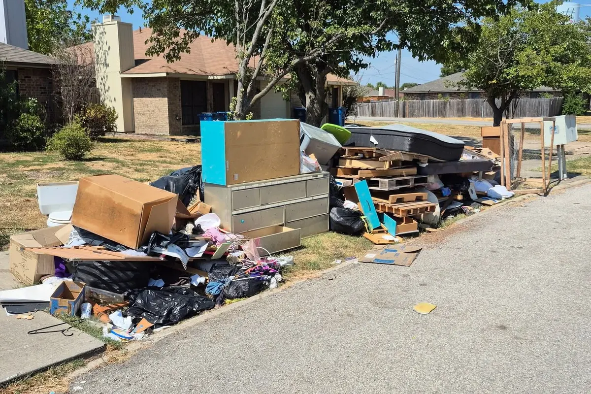 Furniture and junk lined up at the curb for pickup